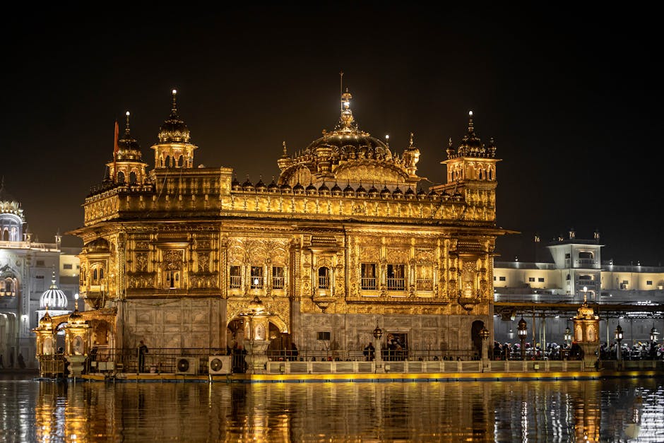 Stunning night view of the illuminated Golden Temple, Amritsar, reflecting in the water.